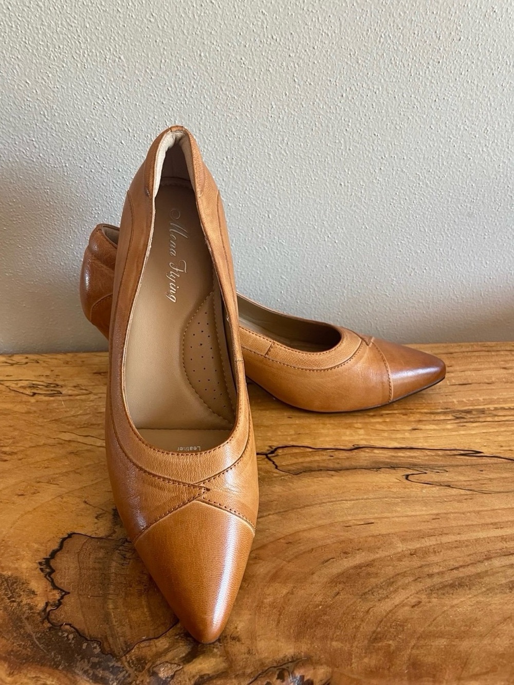 Mona Flying genuine leather pointed toe pumps with stitching details.